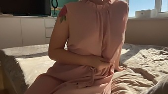 A Lady In A Pink Dress Indulges In Some Sensual Pleasure